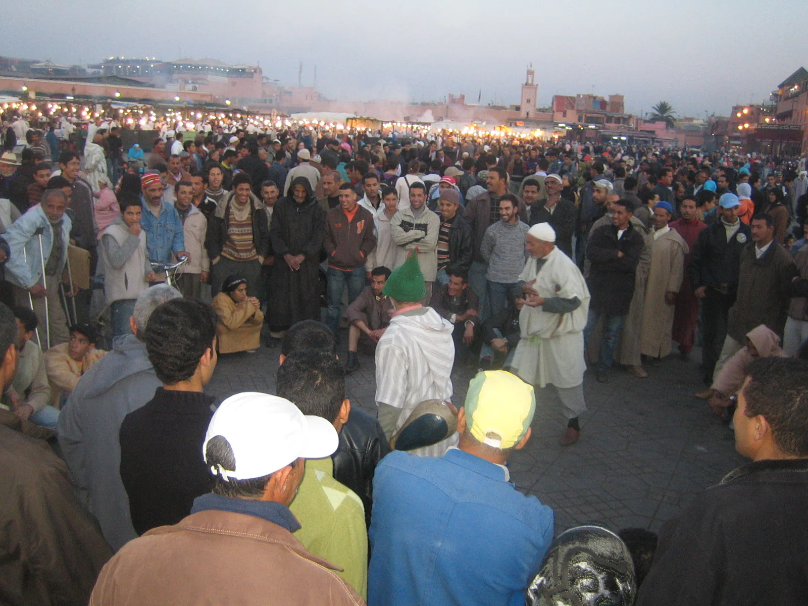 Crowd gathered around storytellers in Jemaa el-Fnaa square, Marrakech
